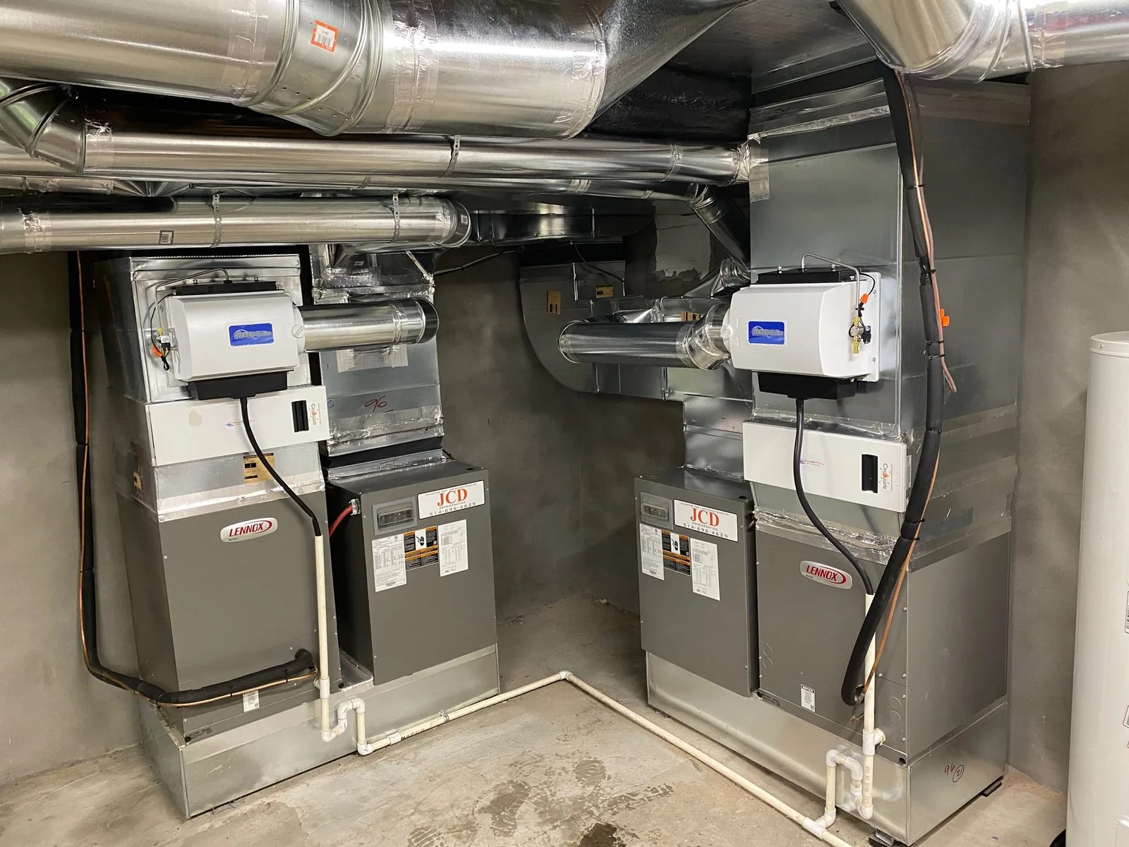 Two Lennox systems with whole-house humidifiers in a mechanical room