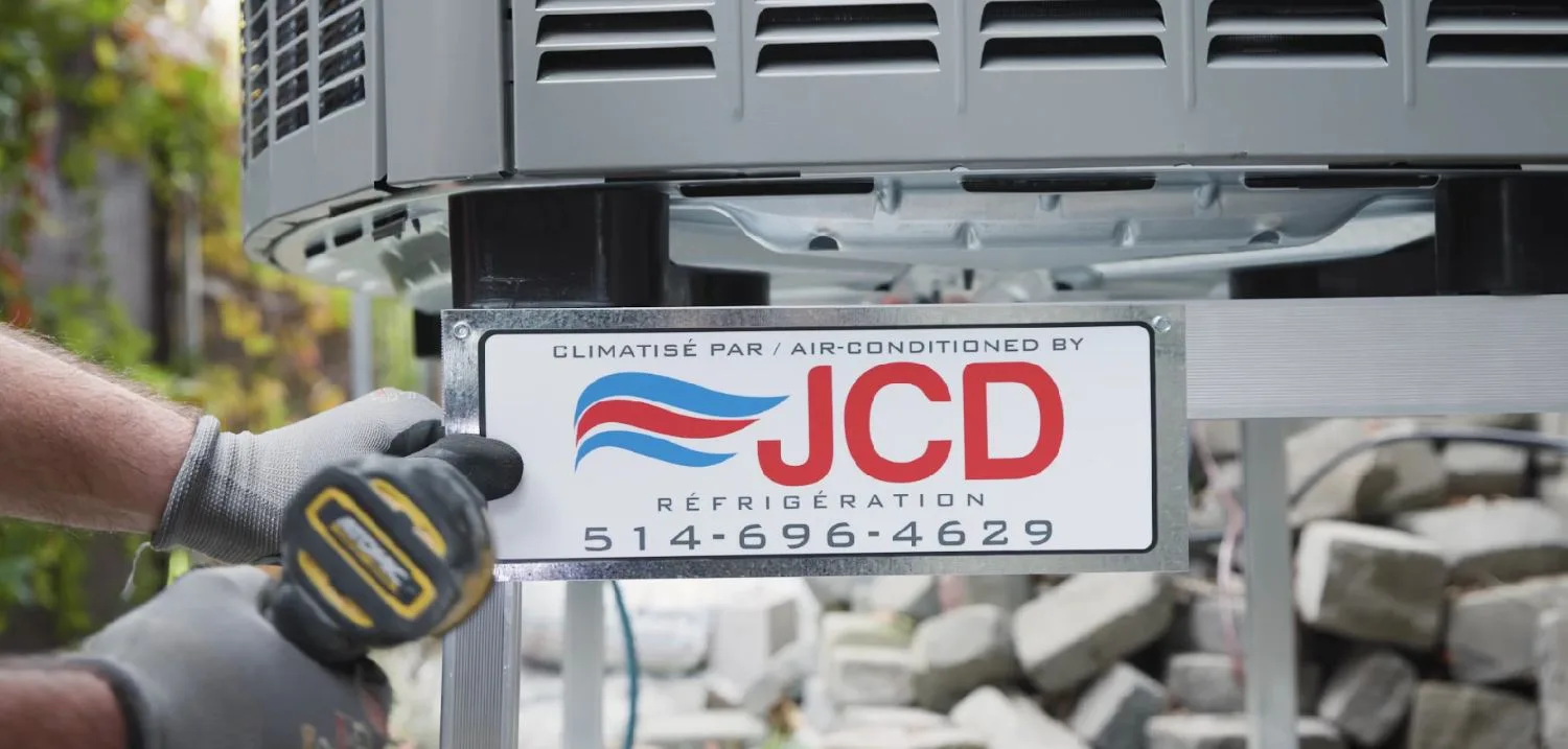 A JCD plate being fixed under an outdoor unit